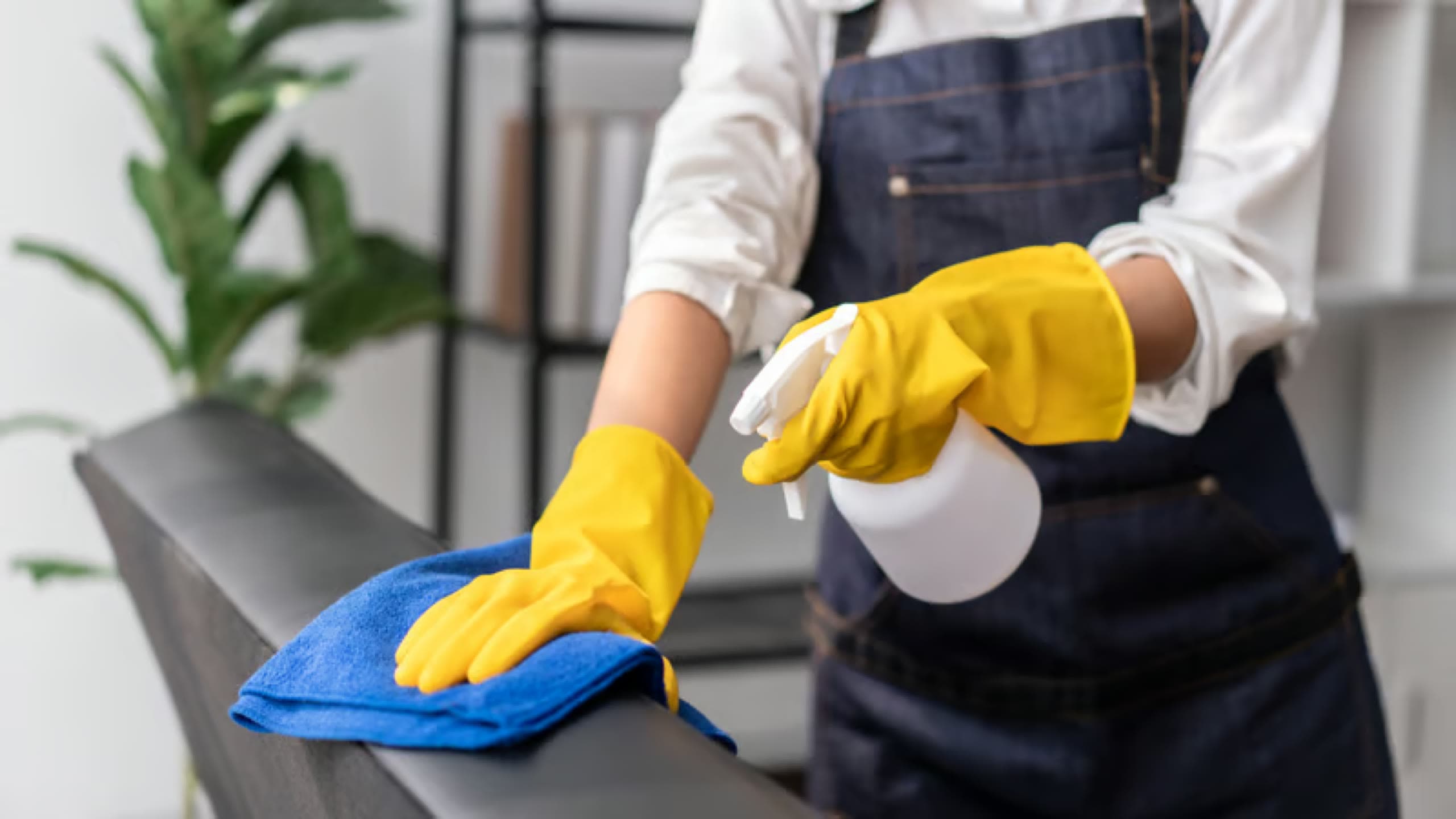 Gloved hand wiping a surface clean during a move-out cleaning